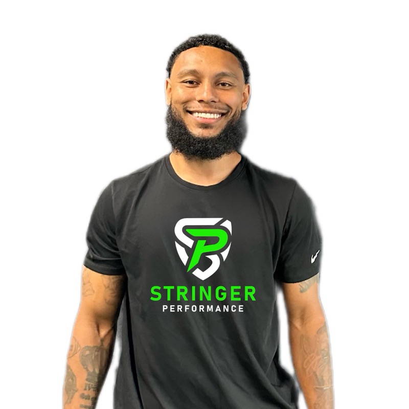 Coach Hassan, smiling, wearing a black Stringer Performance shirt